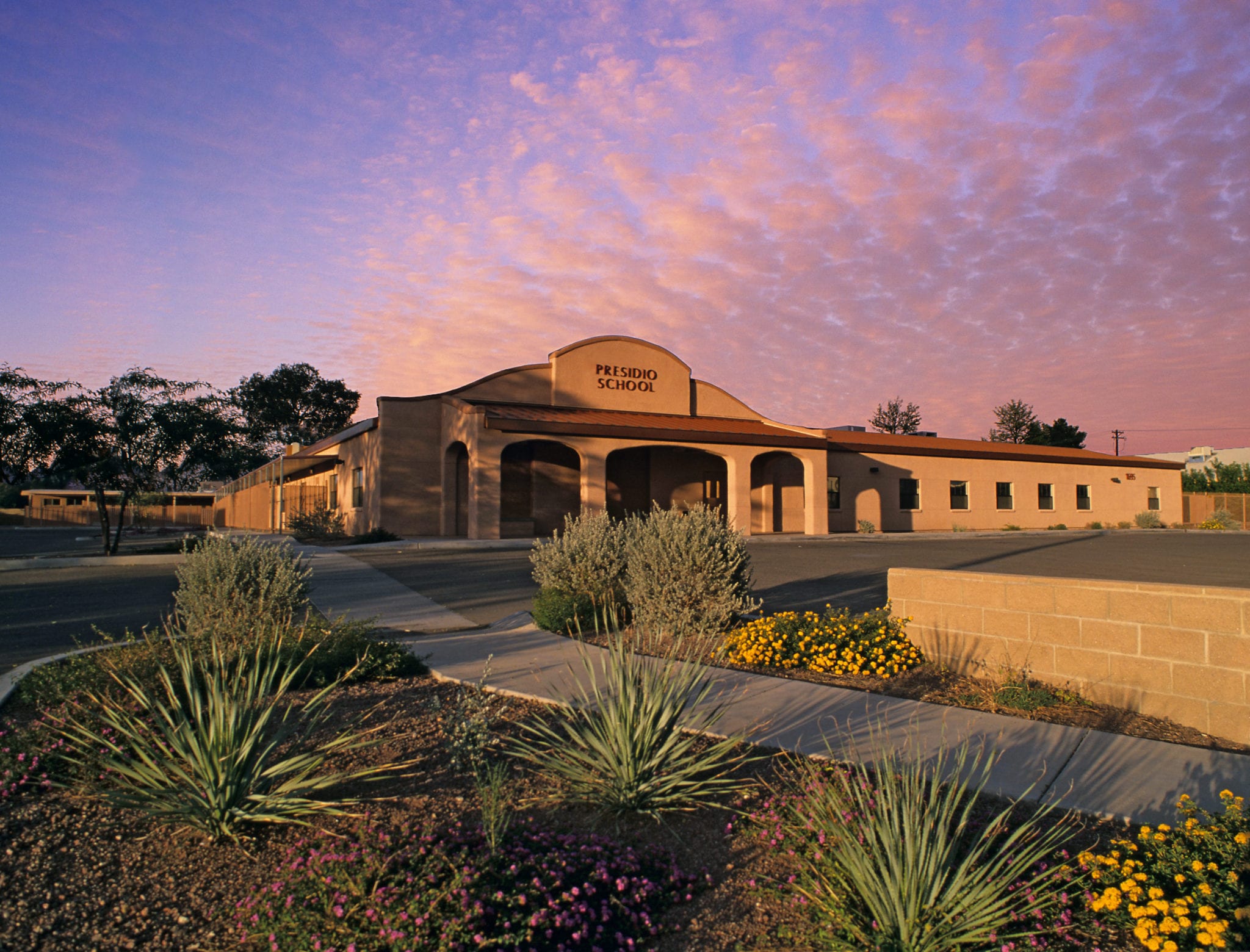 school front office and parking lot at sunset